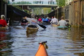 People on boats on the water near buildings