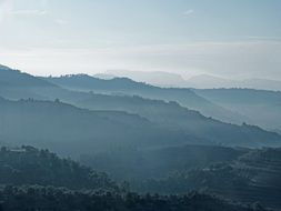 fog over wavy mountains