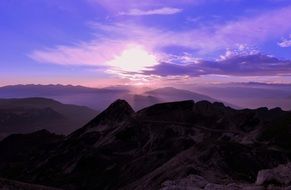 purple sunset over the mountains in italy