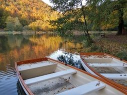 boats on the lake among the autumn forest