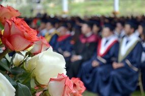 colorful Roses in front of crowd of Graduates