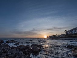 distant view of the sun at sunset over malaga