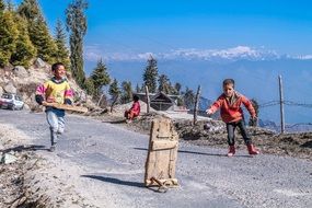 children play on a hill in india