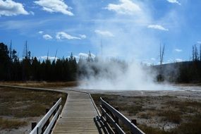 wooden bridge over hot springs in Yellowstone National Park