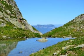 mountain pond and green cliffs in France