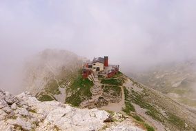 panoramic view of the refuge in the mountains in the fog