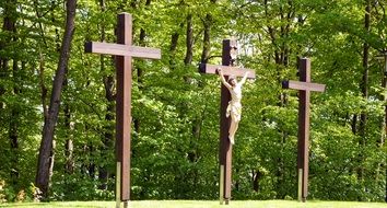 three wooden crosses in the cemetery