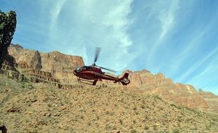 red helicopter over the grand canyon