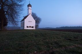 chapel among arable land at dusk