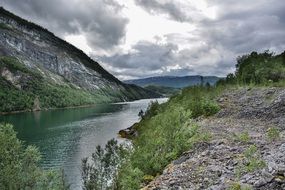dramatic Cloudy Mountains Landscape near Fjord
