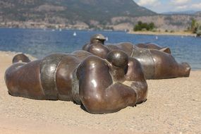 bronze sculptures on the sand beach