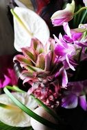 flower arrangement with orchids and mini pineapple