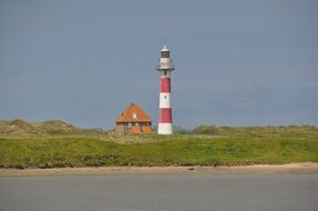 lighthouse on a green field