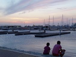 children look at the river with boats