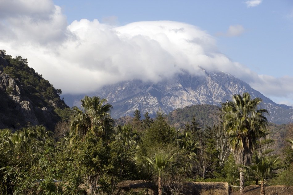 white clouds over the mountains in the jungle