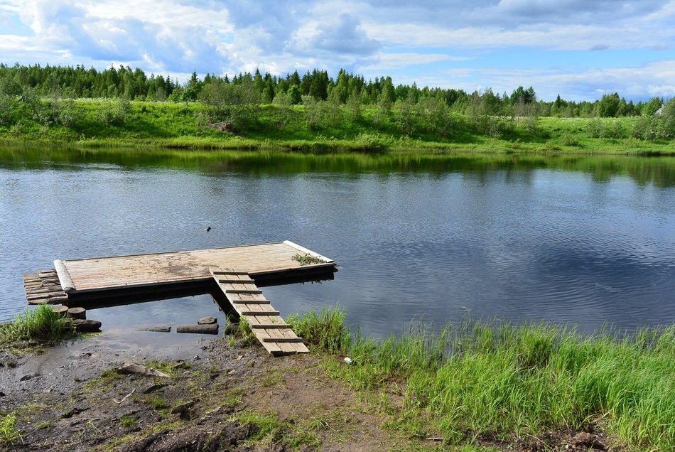 Beautiful landscape with the raft in the water near the shore