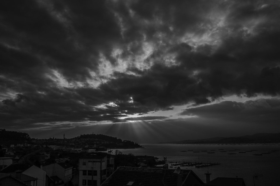 Black and white photo of the beautiful landscape of the shore of Galicia under cloudy sky