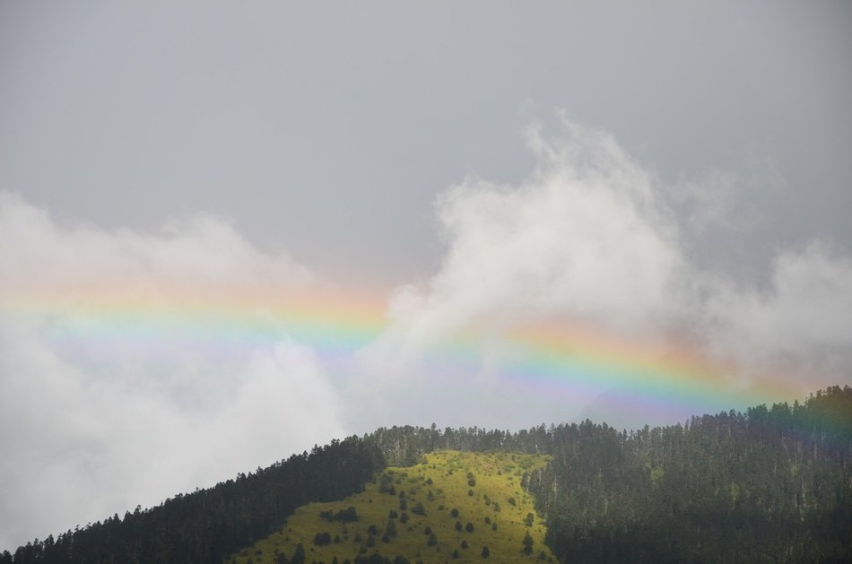 rainbow over the mountains on a cloudy day