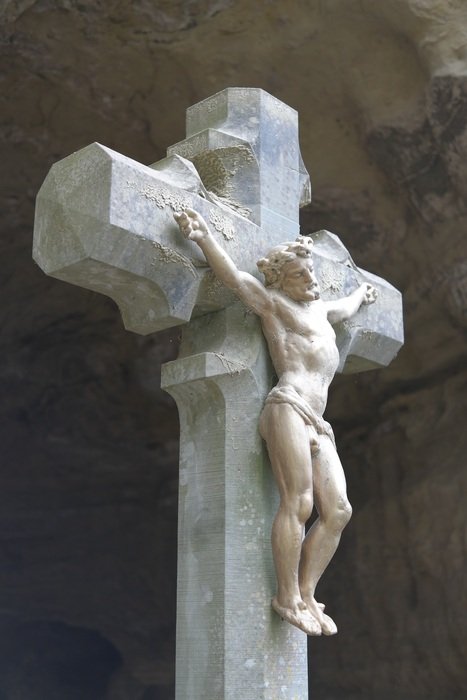 jesus on the cross near the cave