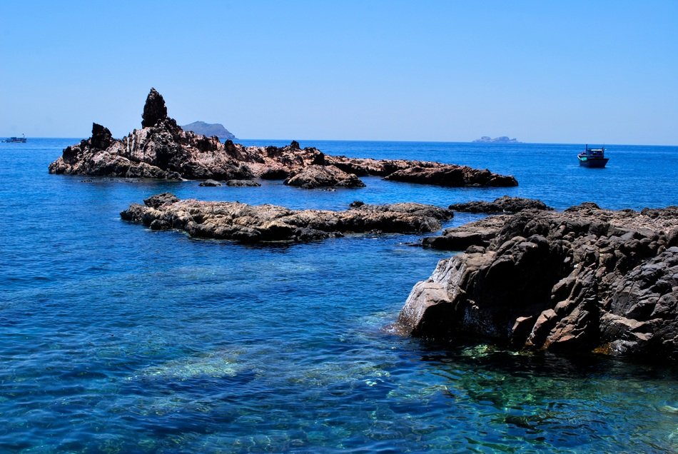 bright blue sea water rock coast view