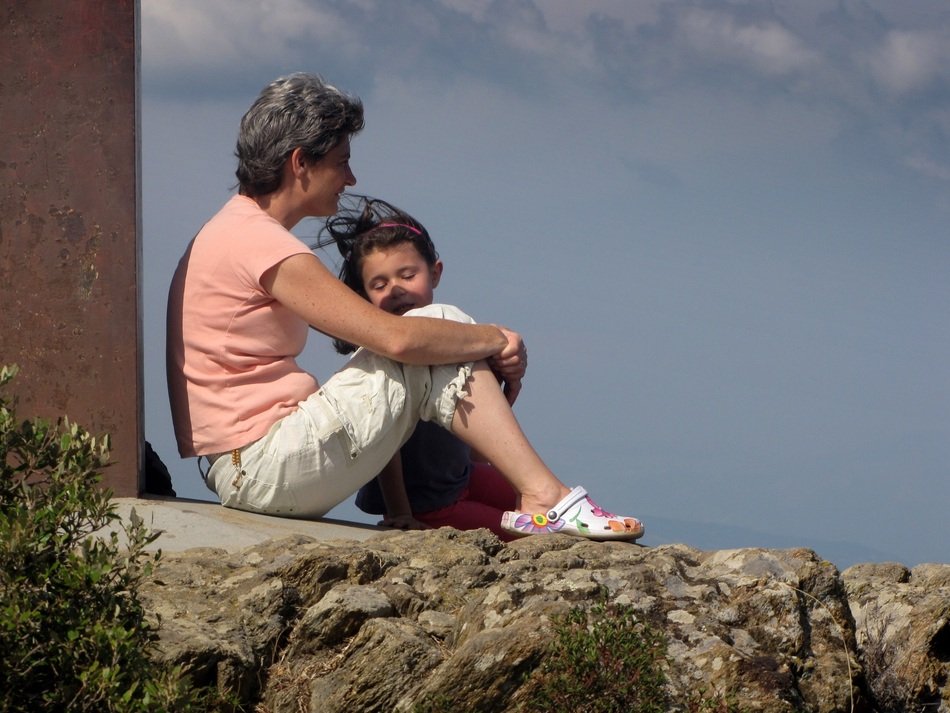 photo of grandmother and child on top of the mountain