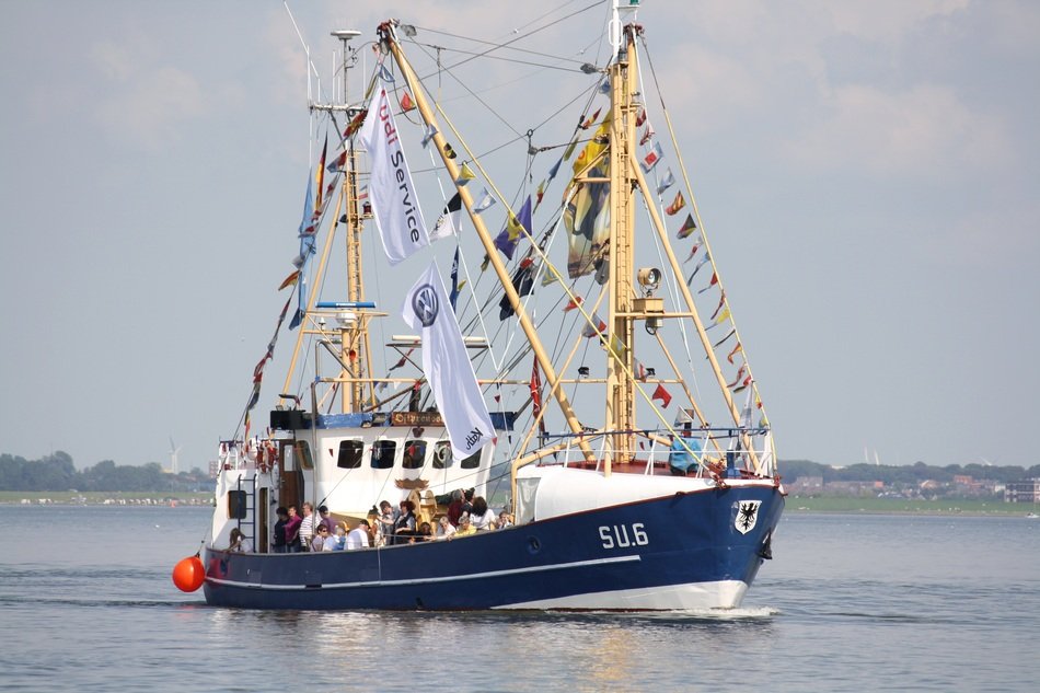 colourful Cutter with flags in North Sea scene
