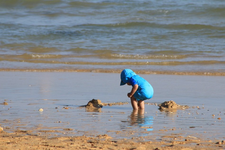 boy play by the sea