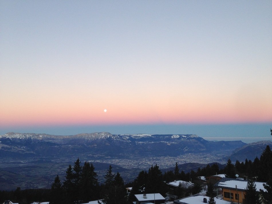 moon over the alps in pink twilight, france