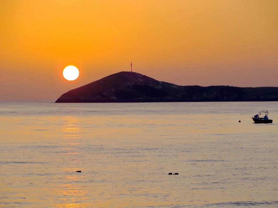 Sun in beautiful orange sky in sunrise above the island in calm sea, Panama