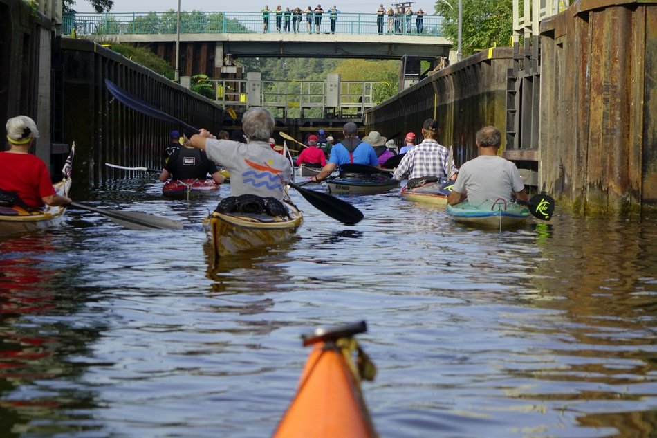 People on boats on the water near buildings