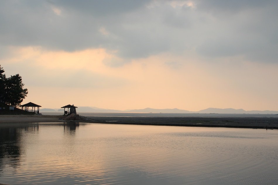 gazebos on the beach at sunset