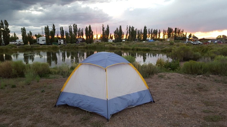 tent near the lake at sunset