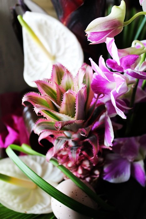 flower arrangement with orchids and mini pineapple