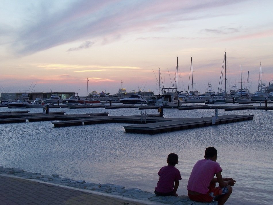 children look at the river with boats