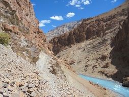 Blue Water stream among brown mountains