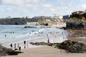 people on sand beach on a sunny day