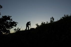 Silhouette of the photographer on the mountain