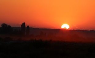 distant view of the bright sun at orange dawn