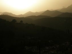 dark Mountain summits at golden Sunset sky