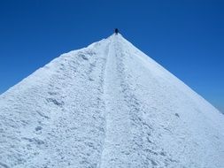 man on top of a snowy mountain