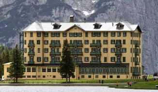 panorama of a mountain hotel at the foot of the mountains