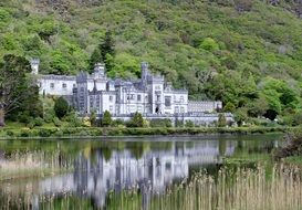 monastery is reflected in the water among the picturesque landscape