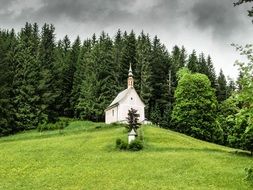 church in the middle of a picturesque landscape in the mountains