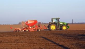 landscape of tractor plows the field