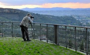 photographer takes a panorama of the city of Perugia from an observation deck, Italy