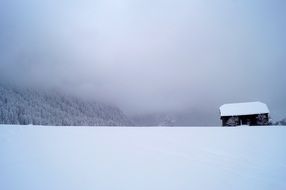 Winter scenery with lonely rural house