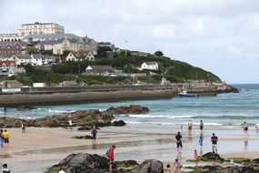 people on the beach on the coast at cornwall