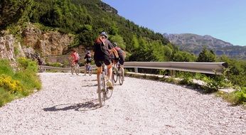 cyclists in mountains on a sunny day