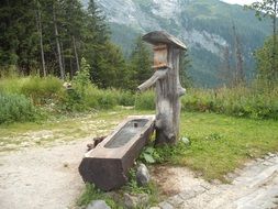 wooden water source in the alps