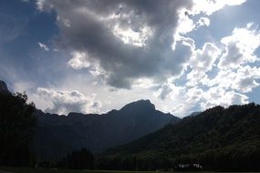 white clouds over the mountains at dusk